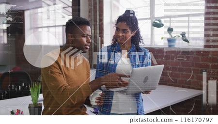 Image of statistical data processing over diverse man and woman discussing over laptop at office 116170797