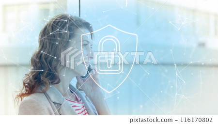 Image of padlock in shield, connected icons over caucasian woman talking on smartphone 116170802