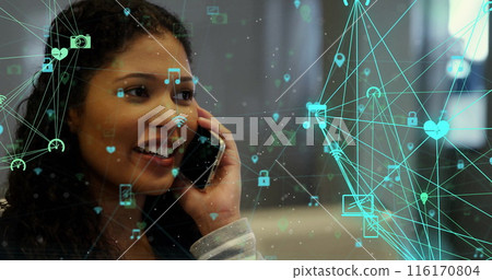 Image of connected icons globe over smiling biracial woman talking on smartphone 116170804