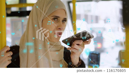 Image of connected icons, biracial woman wearing hijab using voice assistant in bus 116170805