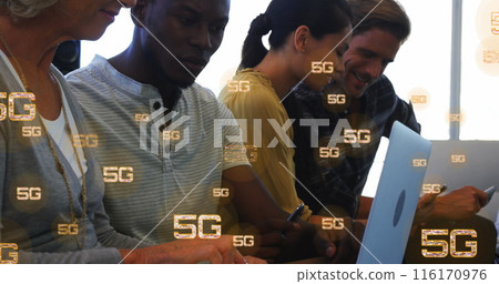Image of multiple 5g texts over diverse coworkers working and using laptop in office Image of multiple 5g texts over diverse coworkers working and using laptop in office 116170976
