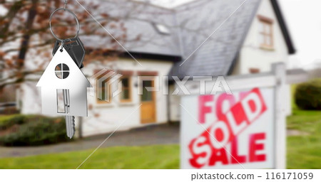 Image of silver house key fob and key, hanging in front of blurred house with sold sign Image of silver house key fob and key, hanging in front of blurred house with sold sign 116171059