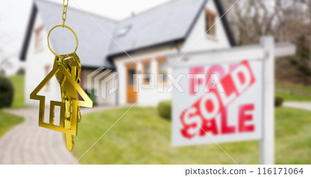 Image of gold house key fob and key, hanging in front of blurred house with sold sign Image of gold house key fob and key, hanging in front of blurred house with sold sign 116171064