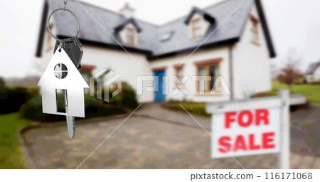 Image of silver house key fob and key, hanging in front of blurred house with for sale sign 116171068