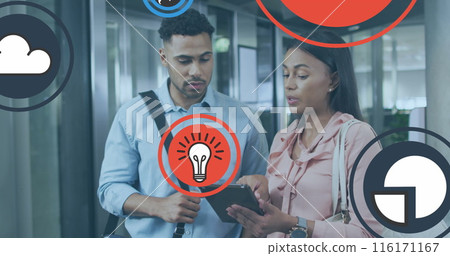 Image of icons over diverse coworkers discussing reports on digital tablet in office Image of icons over diverse coworkers discussing reports on digital tablet in office 116171167