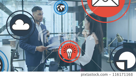 Image of multiple icons over diverse coworkers standing and discussing reports in office Image of multiple icons over diverse coworkers standing and discussing reports in office 116171168