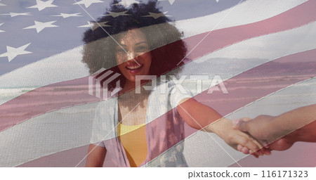 Image of flag of usa over happy african american couple on beach 116171323
