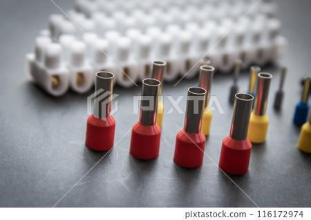 Close up several Wire Ferrule and terminal block w wire on top of a black table 116172974