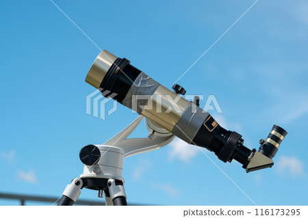 Single solar telescope against clear blue sky. 116173295