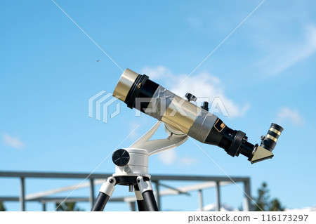 Brass telescope under clear blue sky at observatory. Brass telescope under clear blue sky at observatory. 116173297