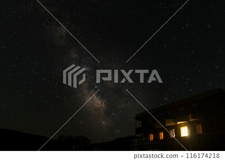 Starry night sky with Milky Way and building 116174218