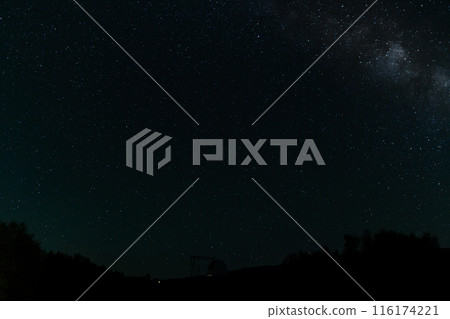 Starry night sky with Milky Way above an observatory silhouette. 116174221