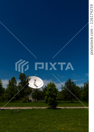 White radio telescope dish in green field White radio telescope dish in green field 116174259