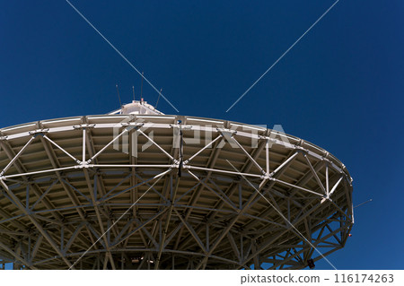 Large satellite dish antenna against clear blue sky. Large satellite dish antenna against clear blue sky. 116174263