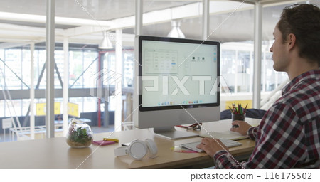 Image of caucasian male colleague, wearing plaid shirt, studying large screen Image of caucasian male colleague, wearing plaid shirt, studying large screen 116175502