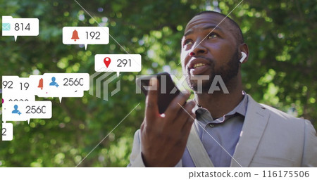 Image of notification bars over african american man talking on speaker of cellphone Image of notification bars over african american man talking on speaker of cellphone 116175506
