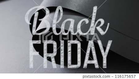 Image of black friday text over rolled up black paper on grey background 116175657