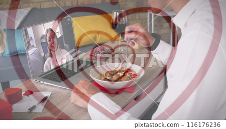 Middle-aged man dining, toasting wine to young girlfriend on laptop Middle-aged man dining, toasting wine to young girlfriend on laptop 116176236