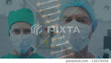 Image of dna strand over caucasian male and female surgeons in face masks 116176356