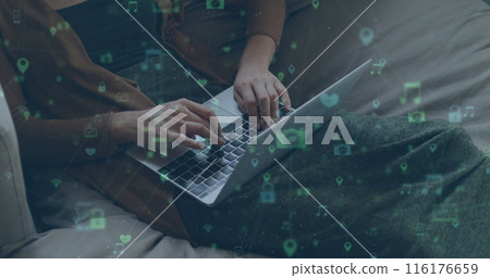 Image of network of connections with social media icons over caucasian women using laptop Image of network of connections with social media icons over caucasian women using laptop 116176659