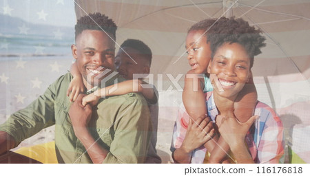 Image of flag of usa over african american family at beach 116176818