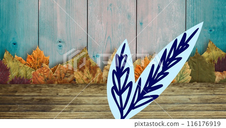 Image of leaves and leaf drawing on wooden background 116176919