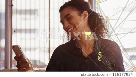 Biracial college student holding smartphone, smiling with joy 116177934