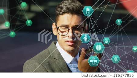 Biracial young adult wearing glasses interacting with virtual icons Biracial young adult wearing glasses interacting with virtual icons 116177936