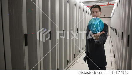 Caucasian colleague in suit holding holographic globe in data center 116177962