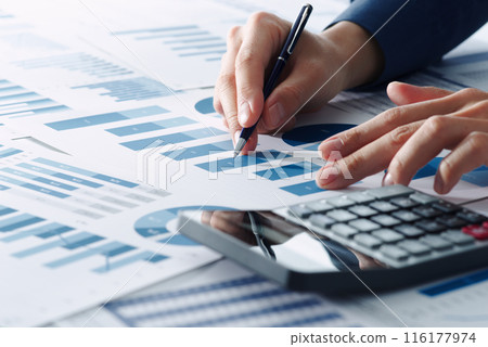 Image of business financial analysis. Analyst thinking about business strategy. Manager's hand pointing at graph among many reports 116177974