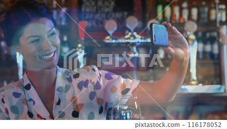 Image of flickering lights over biracial woman using smartphone 116178052