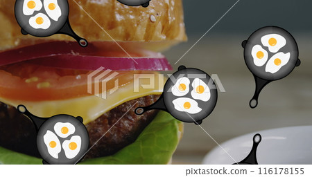 A hamburger with eggs floating around it rests on plate 116178155