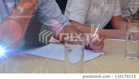 Person wearing pink shirt writing on paper, another in white rolling up sleeves Person wearing pink shirt writing on paper, another in white rolling up sleeves 116178518