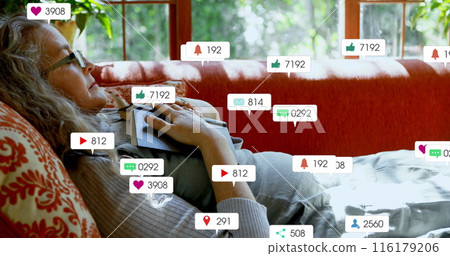 Image of social media icons over caucasian senior woman with book sleeping on the couch at home Image of social media icons over caucasian senior woman with book sleeping on the couch at home 116179206