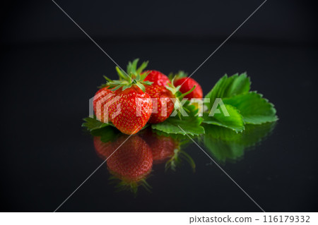 red ripe strawberry spring on a black background red ripe strawberry spring on a black background 116179332