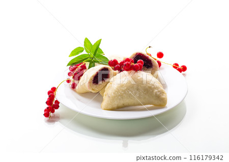 steamed sweet homemade dumplings with berries, red currants 116179342