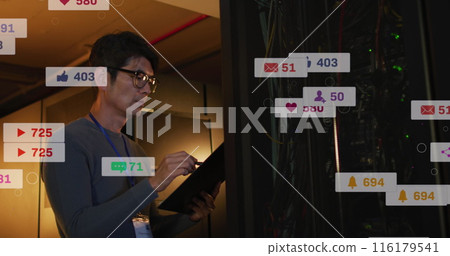 Image of social media icons over asian male engineer writing on clipboard at server room Image of social media icons over asian male engineer writing on clipboard at server room 116179541
