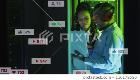Image of social media icons and numbers over diverse it technicians by computer servers Image of social media icons and numbers over diverse it technicians by computer servers 116179550
