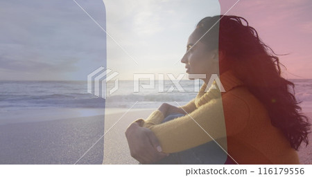 Image of flag of france over biracial woman sitting at beach Image of flag of france over biracial woman sitting at beach 116179556