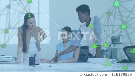 Image of connected icons forming globe over diverse female architects discussing blueprint 116179839