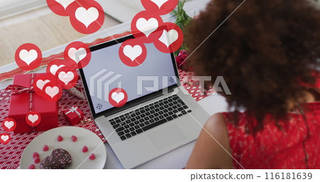 Image of heart icons over african american woman using laptop with copy space, slow motion Image of heart icons over african american woman using laptop with copy space, slow motion 116181639
