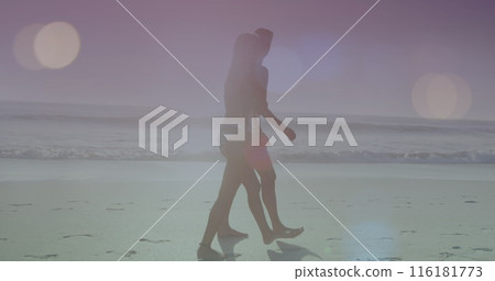 Image of illuminated lens flares over caucasian couple walking at beach during sunny day Image of illuminated lens flares over caucasian couple walking at beach during sunny day 116181773