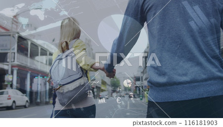 A caucasian couple is walking around a city, holding hands and smiling 116181903