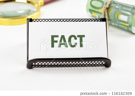 Business concept. FACT word on a business card in a composition with Euro banknotes and a magnifying glass out of focus Business concept. FACT word on a business card in a composition with Euro banknotes and a magnifying glass out of focus 116182309