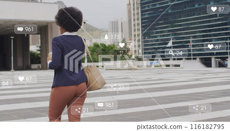 African American career woman, wearing navy blazer and tan pants, holding smartphone 116182795