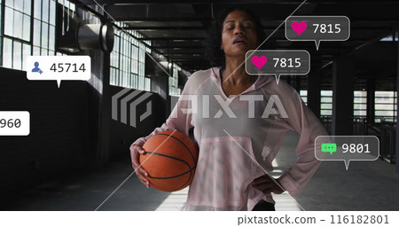 Biracial woman holding basketball, wearing pink sports top 116182801