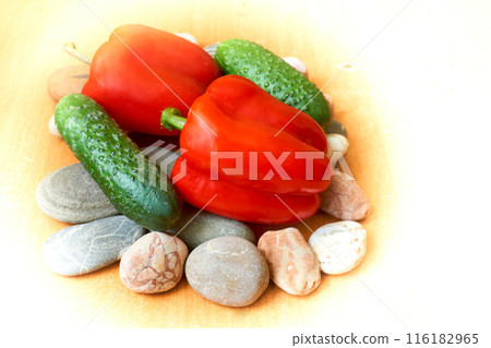 Two red sweet peppers, two green cucumbers on stones Two red sweet peppers, two green cucumbers on stones 116182965