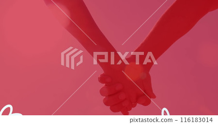 Two people holding hands against pink background Two people holding hands against pink background 116183014