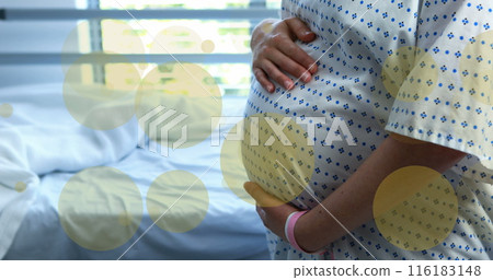 Image of green spots over biracial pregnant woman touching her stomach in hospital Image of green spots over biracial pregnant woman touching her stomach in hospital 116183148