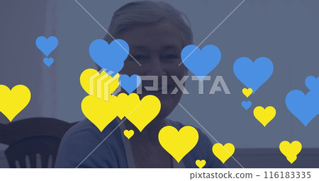 Image of blue and yellow hearts over senior caucasian woman using tablet 116183335